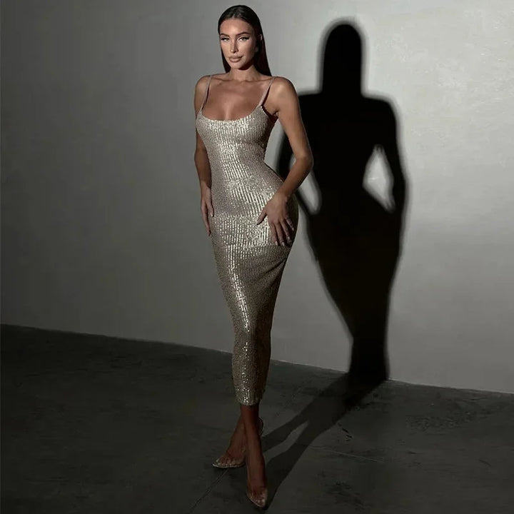 "Black sequined spaghetti-strap dress with a delicate and elegant design, perfect for special occasions."