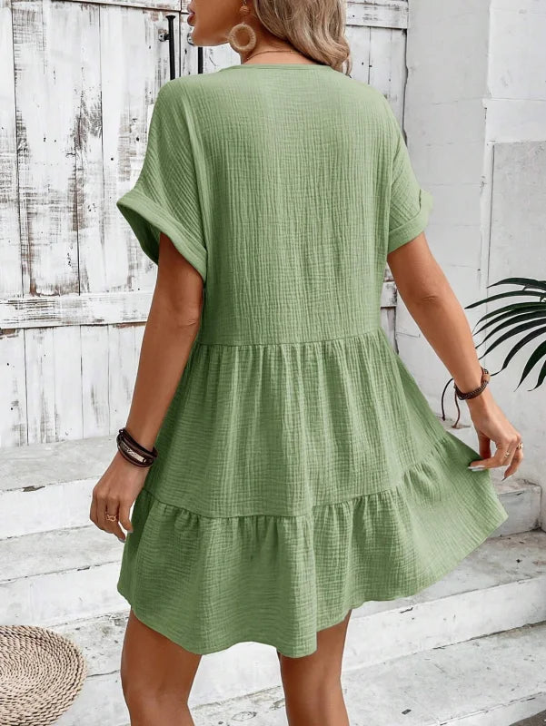 Flowy V-neck mini dress with pleated skirt in soft, breathable fabric - Abriella offers a feminine and chic look for any…