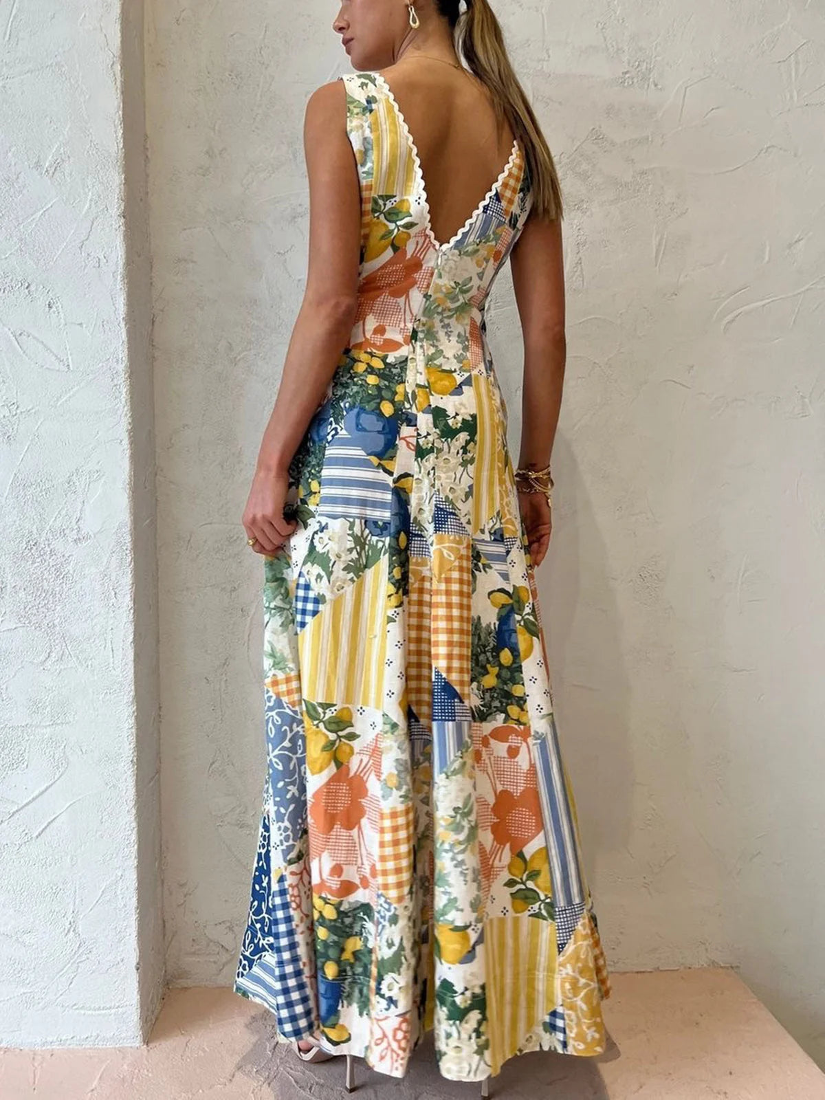 "Addelyn sleeveless maxi dress in blue with geometric pattern, V-neck, and flowy silhouette, perfect for summer days."