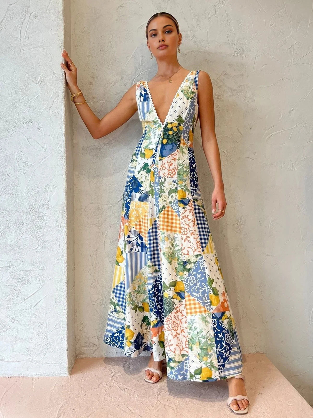 Sleeveless V-neck maxi dress in a white, blue, green, and yellow pattern, perfect for sunny days.