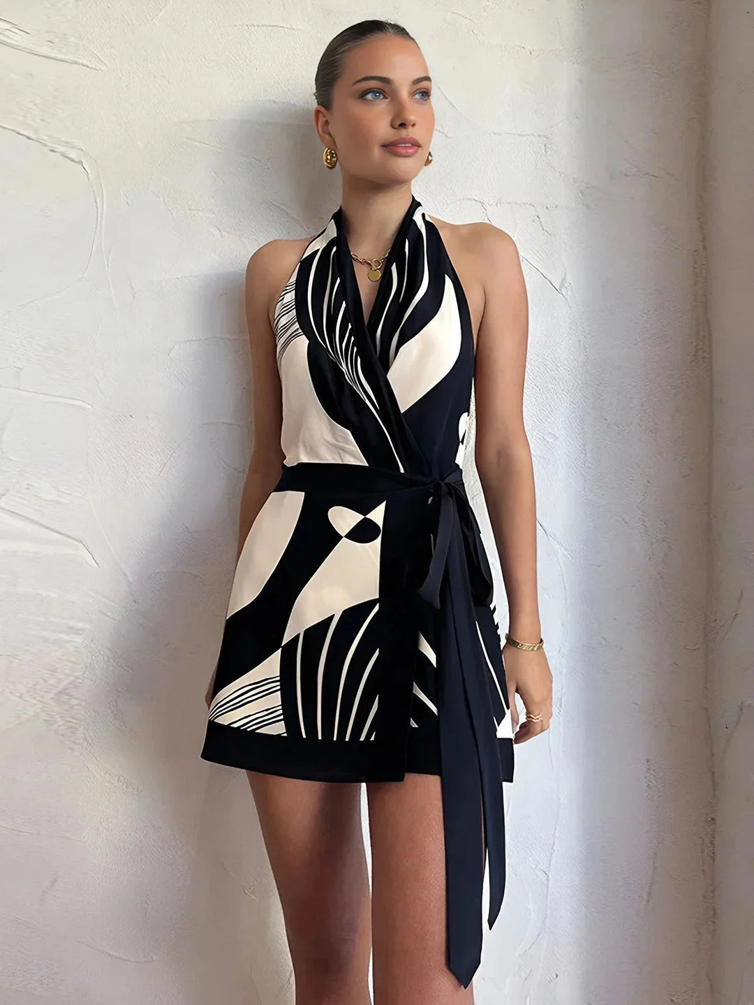 Black and white patterned halter wrap dress with a unique design, perfect for a stylish and chic look.