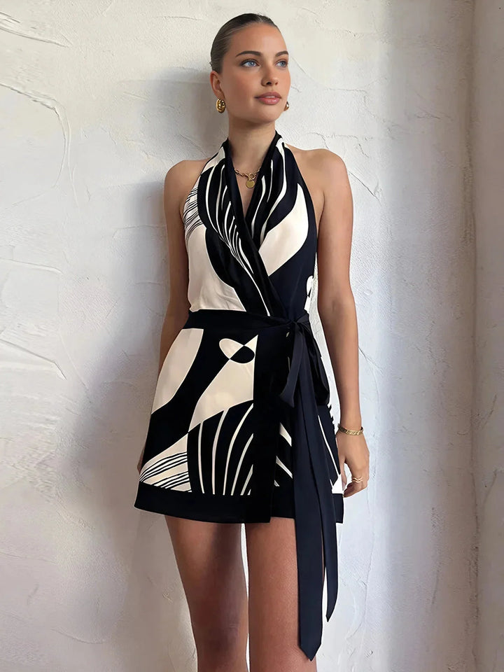 Black and white patterned halter wrap dress with a unique design, perfect for a stylish and chic look.