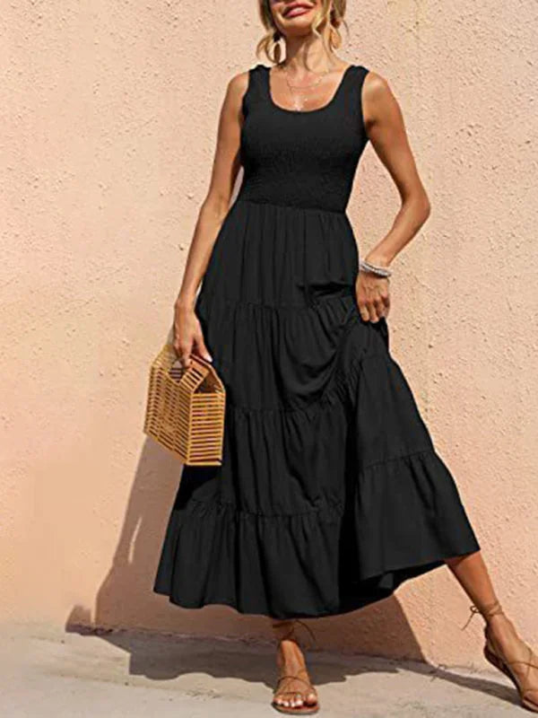 Black sleeveless tiered maxi dress with a V-neck made from soft, flowy fabric, perfect for casual summer days or evening…