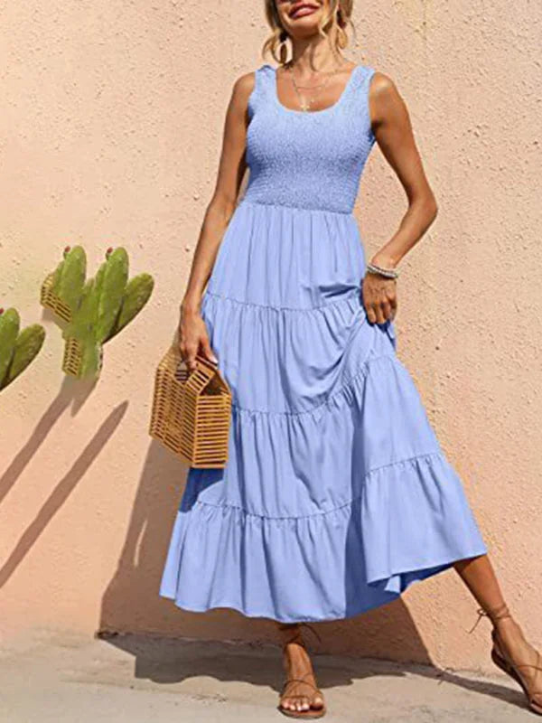 Light blue tiered maxi dress with a sleeveless design, made from breathable fabric. Perfect for a breezy summer day.