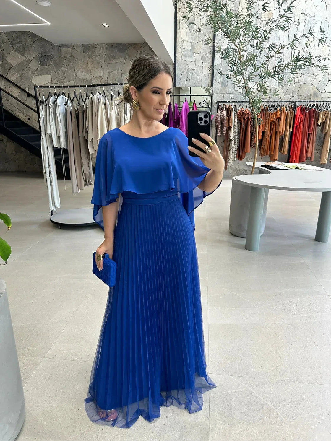 Aisley pleated maxi dress in navy blue with flowing cape sleeves, made from lightweight chiffon fabric.