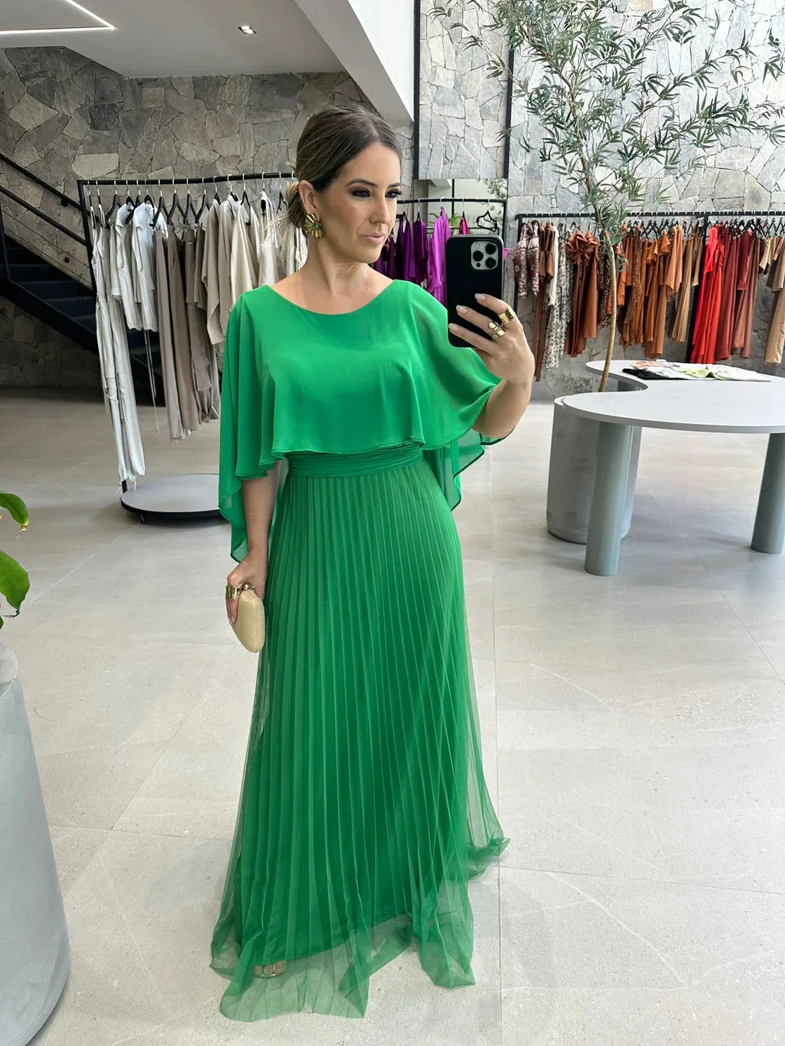 Green pleated maxi dress with cape sleeves, elegant and flowy design for special occasions, perfect for a sophisticated yet…