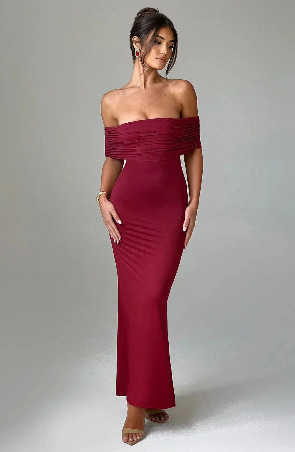 "Red off-shoulder ruched party dress with a flattering silhouette suitable for special occasions, featuring a sleek and…