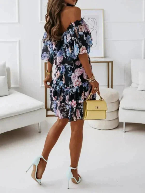 Women's floral dress with tiered skirt in light cotton fabric, featuring a vibrant spring print and a flattering silhouette.