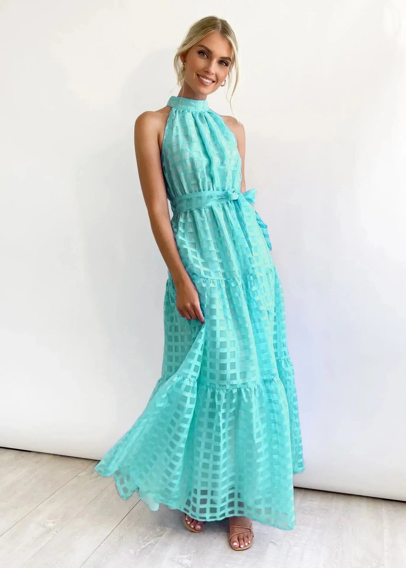 Cyan tiered halter neck summer dress with a lightweight flowy fabric and a bohemian design perfect for sunny days.