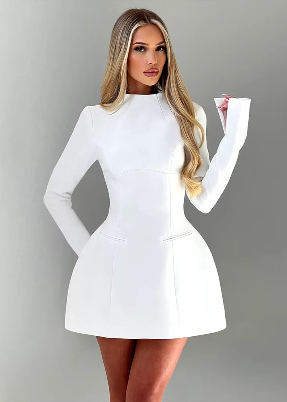 Alessandra mini dress in white, featuring a flared design and open back detail, perfect for elegant occasions.