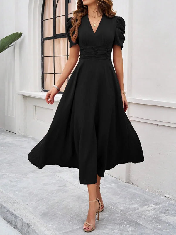 Navy midi dress with ruched waist, V-neck and tie sleeves in soft rayon fabric.