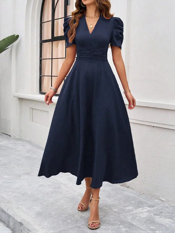 Navy blue midi dress with ruched waist, V-neck, and versatile style perfect for any occasion.