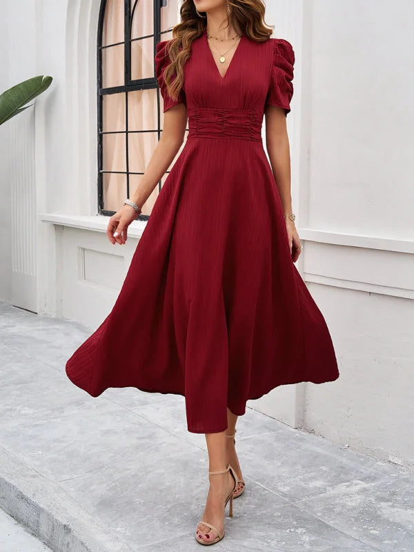 Ruched waist V-neck midi dress in breathable cotton blend with flattering silhouette for effortless chic look.