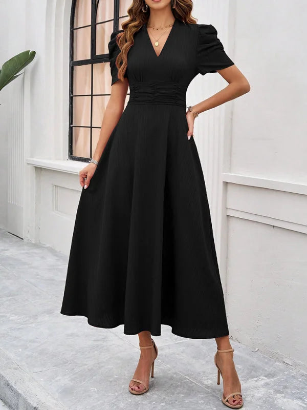 Ruched waist V-neck midi dress in a soft, flowing fabric with a stylish design, perfect for a casual or formal occasion.