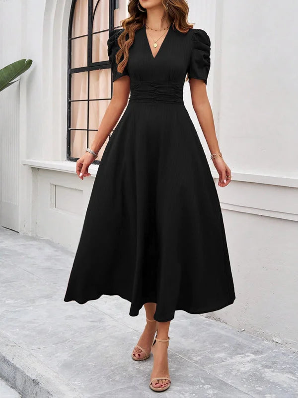 Black V-neck midi dress with a flattering ruched waist, perfect for effortless style.