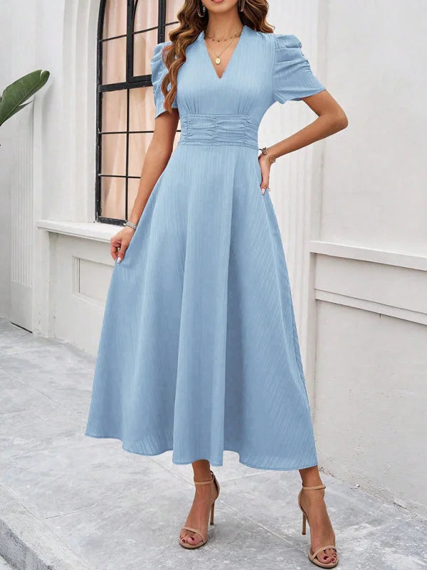 Clear blue midi dress in soft cotton blend fabric, featuring a V-neck, ruched waist, and midi length.