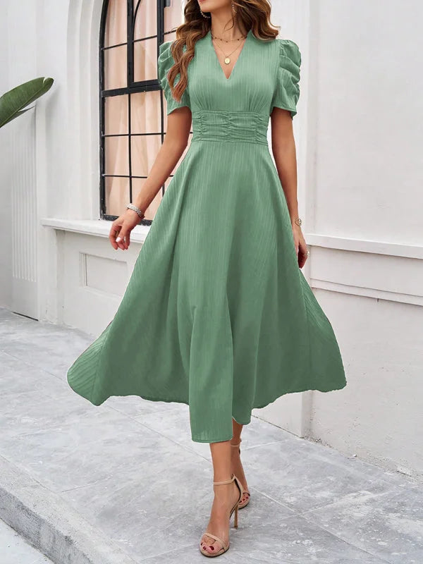 Green midi dress with ruched waist, V-neck, and flattering silhouette. Made from soft and stretchy fabric for all-day…