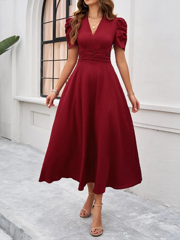 Red V-neck midi dress with ruched waist, made of soft jersey fabric. Flattering silhouette perfect for everyday wear or…