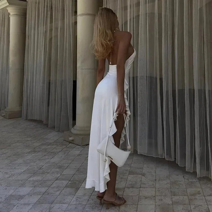 White halter midi dress with cascading ruffles. Elegant, flowy design perfect for special occasions or summer events.