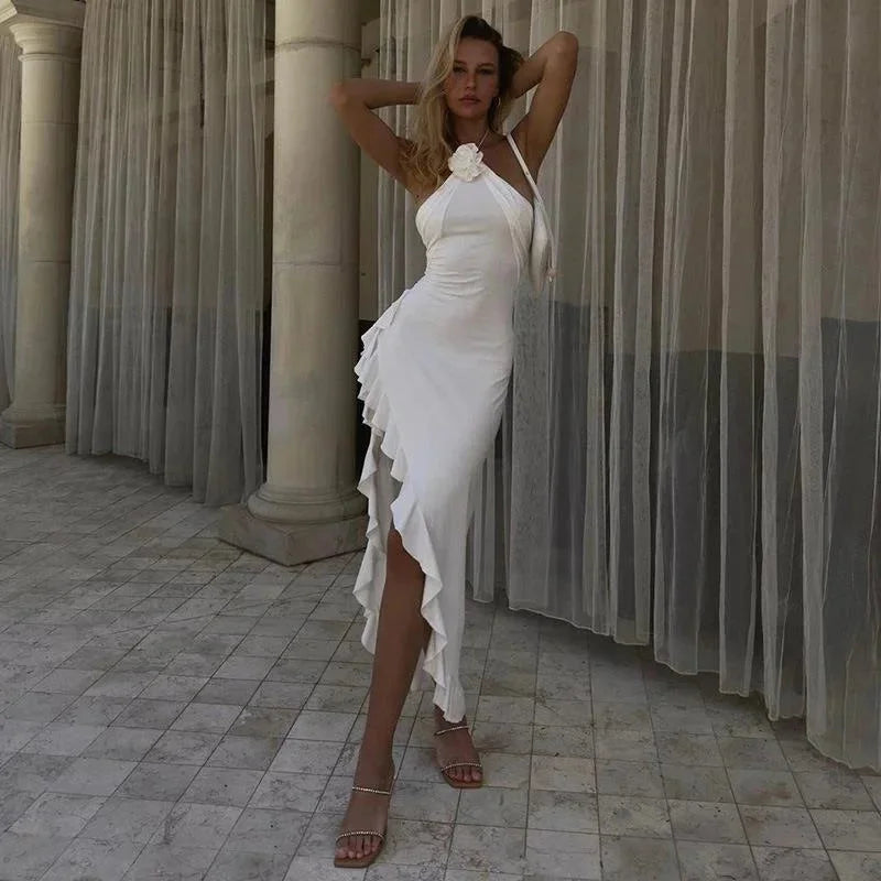 White halter midi dress with cascading skirt, perfect for summer. Made of lightweight flowy fabric, ideal for a breezy day…