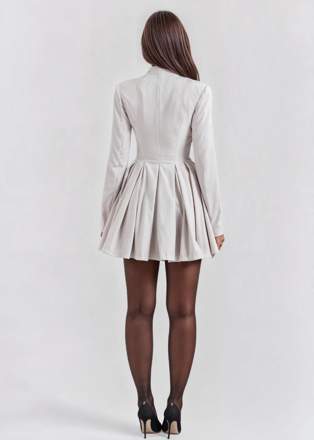 Cream flared mini dress with deep V-neckline, featuring a stylish design perfect for casual or dressed-up occasions.