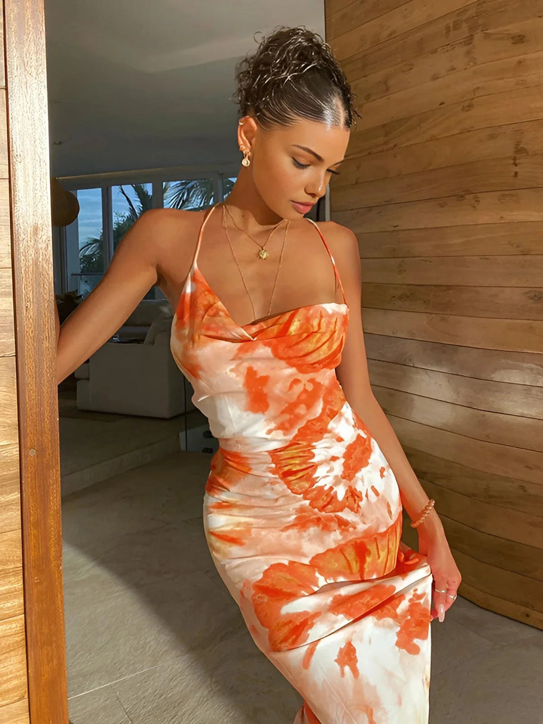 "Sleeveless floor-length orange floral dress with a vibrant design suitable for any occasion."