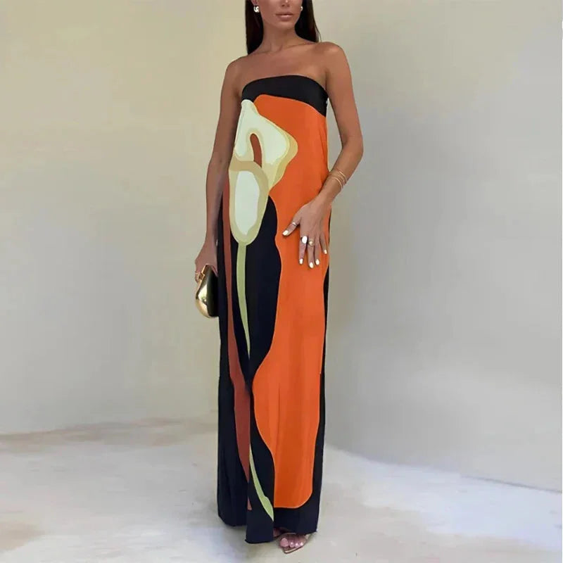 "Orange strapless maxi dress with abstract print design, made from lightweight and breathable fabric. Perfect for a casual…