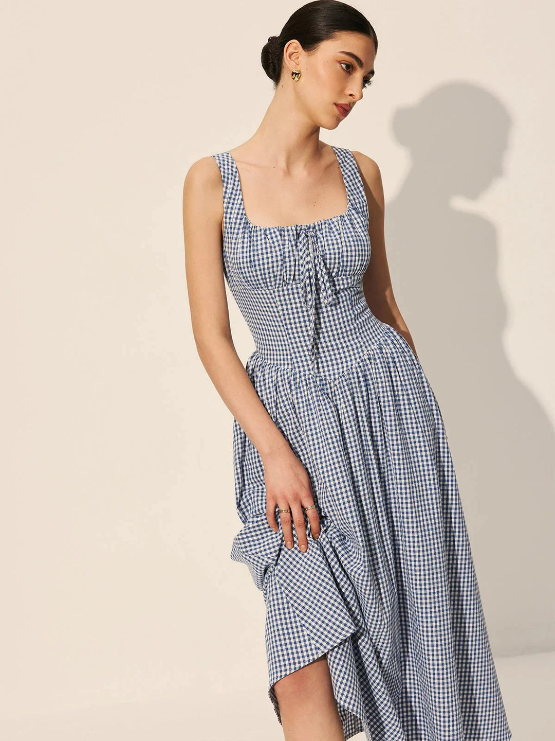 "Sleeveless navy gingham midi dress made of cotton, perfect for a casual chic look."