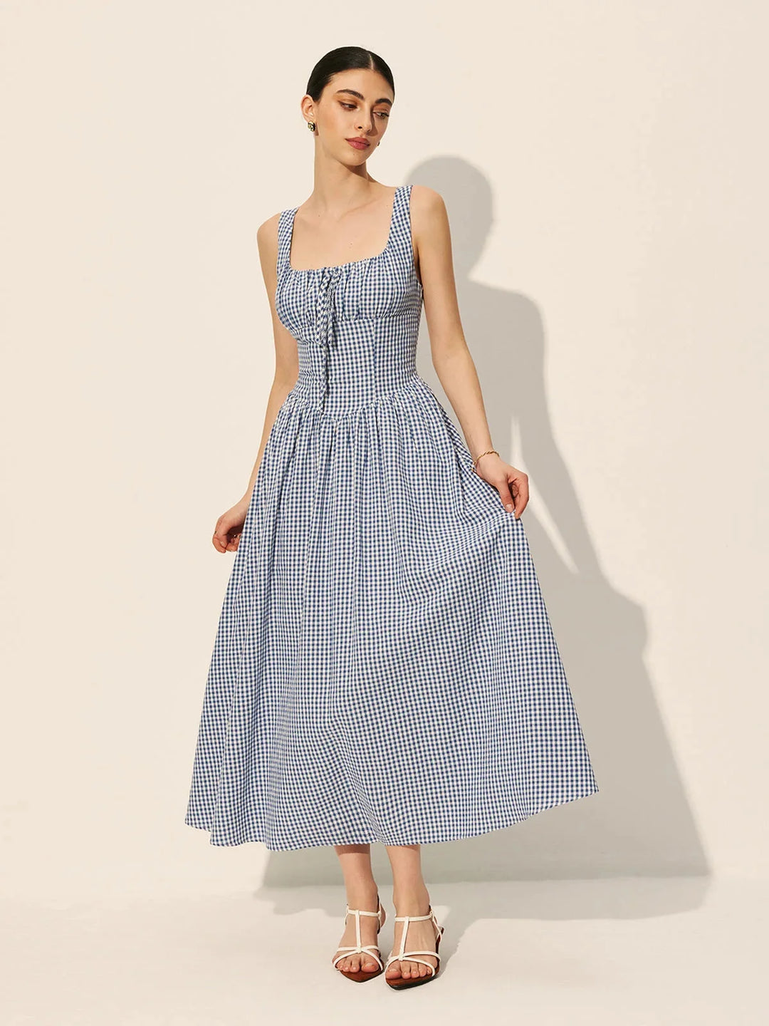 "Sleeveless navy gingham midi dress made of comfortable cotton fabric."