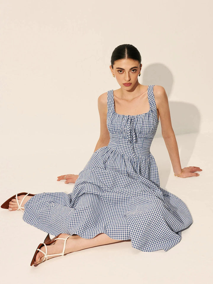 "Sleeveless navy gingham midi dress made of cotton, perfect for a casual yet chic look."