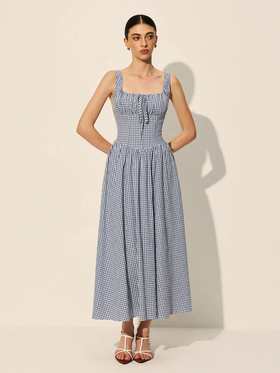 "Sleeveless navy gingham midi dress made of comfortable cotton fabric in a classic blue color"