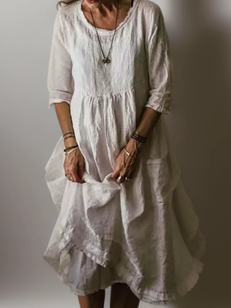 White maxi dress with 3/4 sleeves and a breezy design. Made with lightweight, flowy fabric perfect for casual or formal…