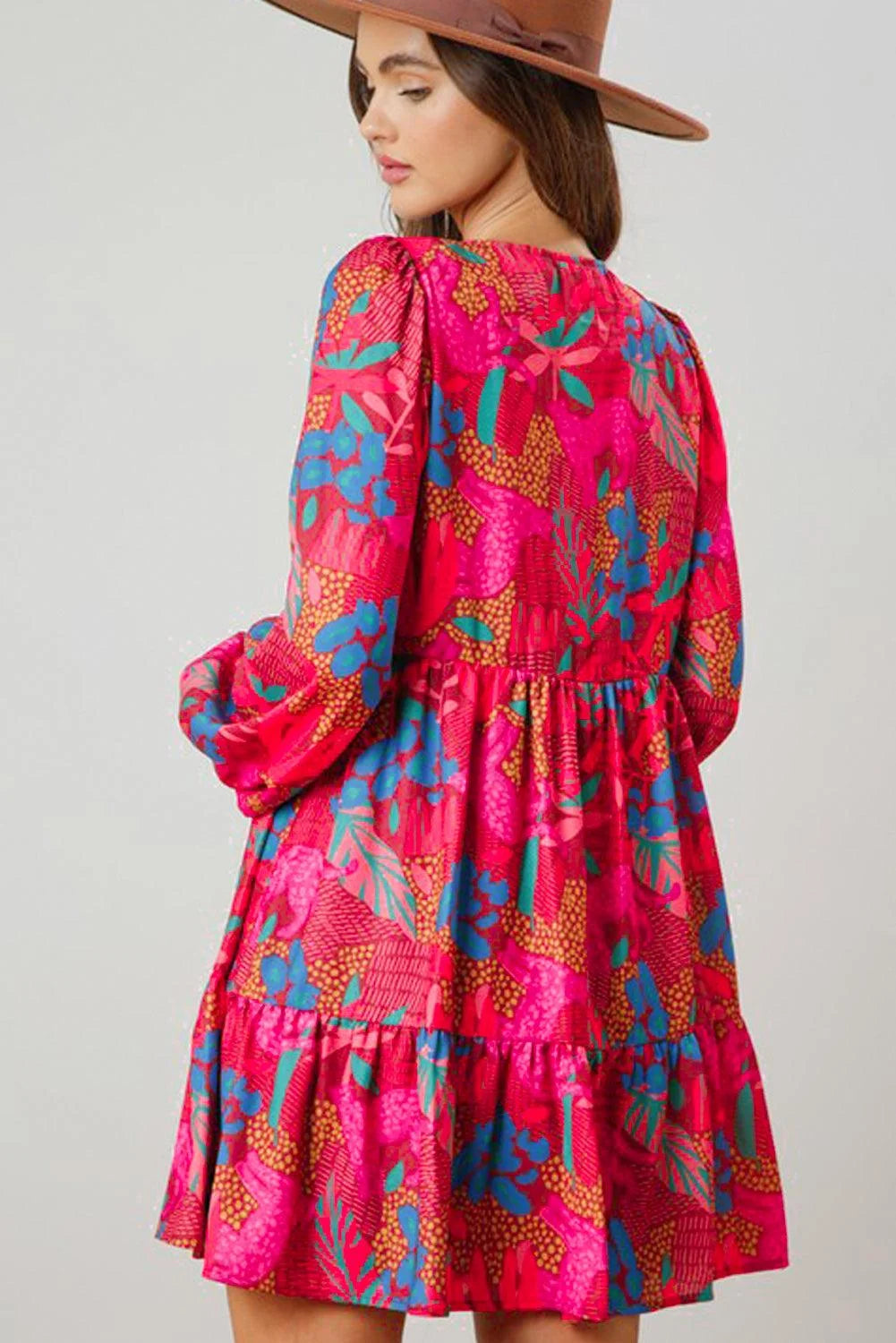 Amani mini dress with bright floral print, ruffled sleeves, and A-line silhouette in lightweight cotton fabric.