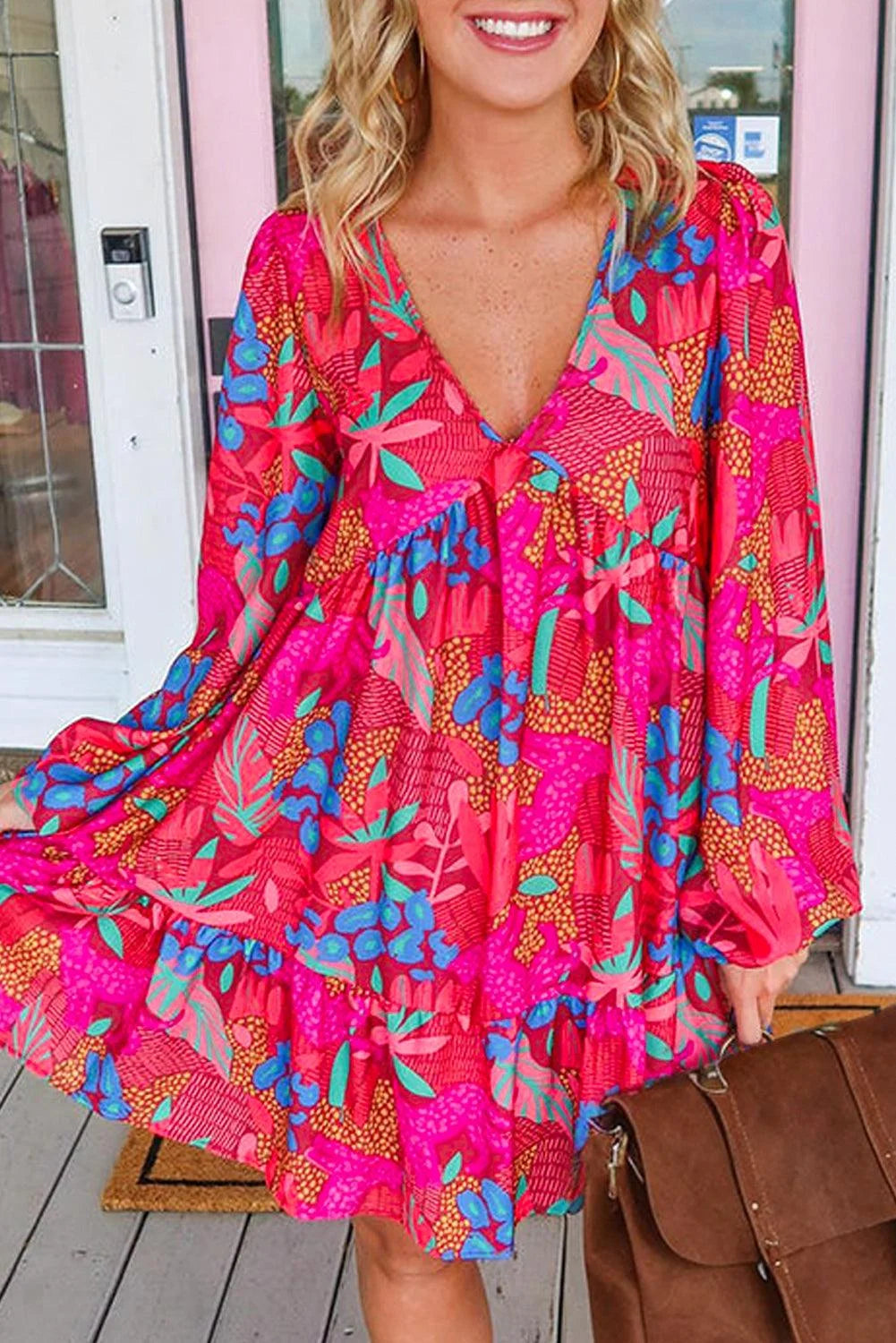 Rose Amani dress features bright floral print, ruffled sleeves, ideal for spring/summer.