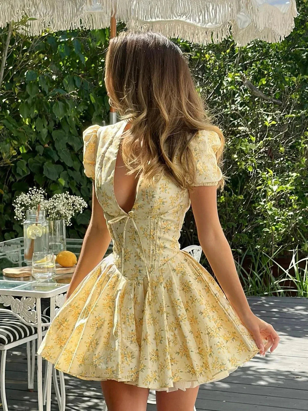 "Yellow floral dress with puff sleeves for women, featuring a charming design and lightweight, breathable material."