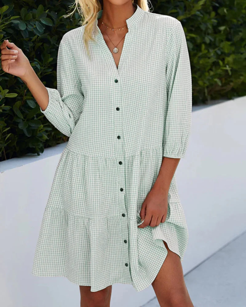 Green button-up midi dress in relaxed fit, featuring a v-neckline and short sleeves. Made of soft, breathable fabric for…