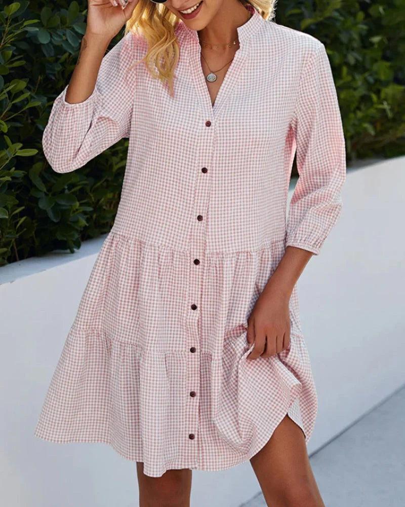 Pink button-up midi dress in relaxed fit. Features buttons, collar, and pockets. Perfect blend of style and comfort for…