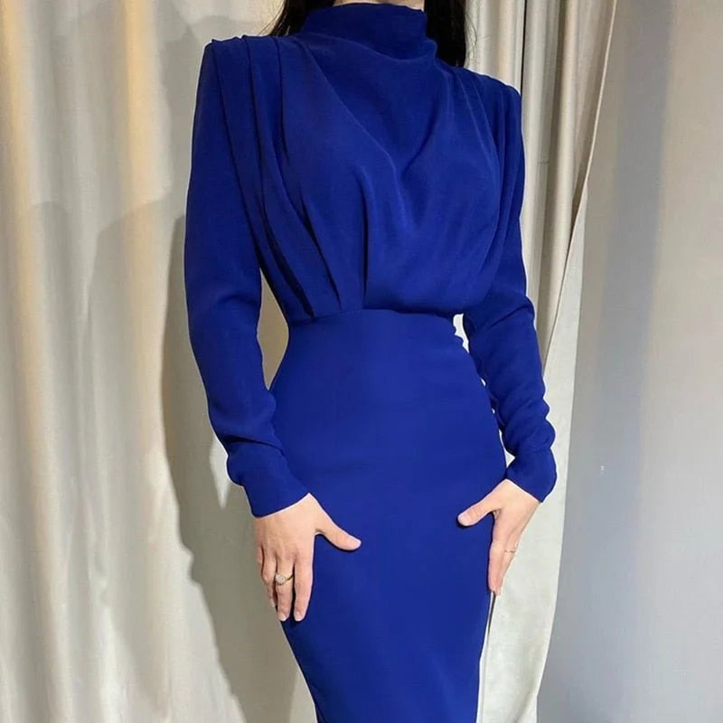 Royal blue high-neck maxi dress with a stylish design, perfect for fall events. Crafted from soft, flowing material for a…