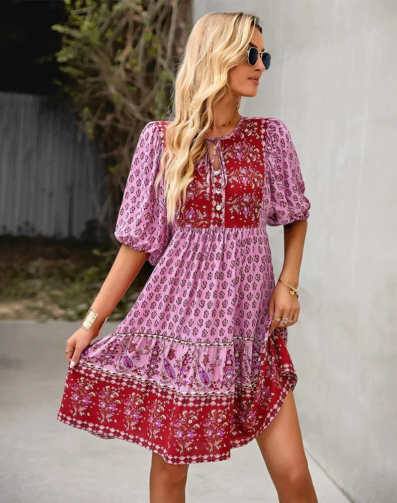 "Bohemian patchwork midi dress featuring various patterns and textures in a soft and flowing fabric."