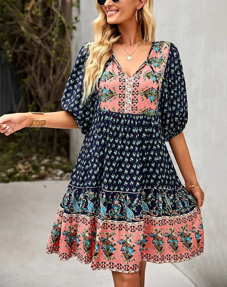 "Bohemian patchwork midi dress with various patterns in soft and flowy fabric."