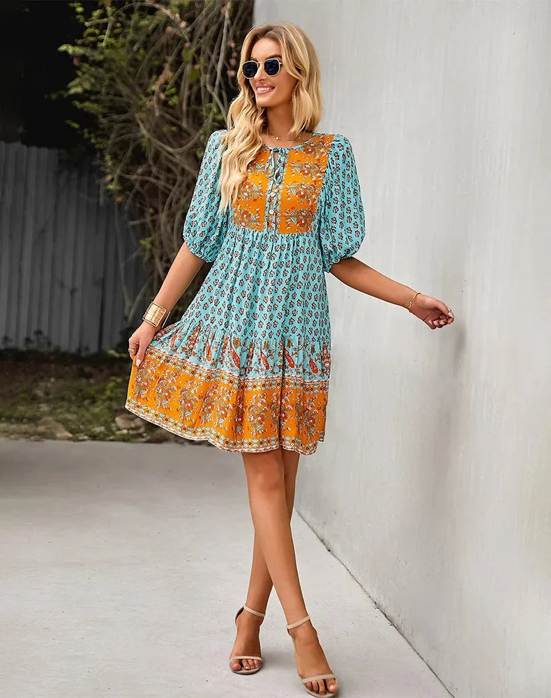 "Bohemian patchwork midi dress with intricate floral patterns in soft and flowy fabric."