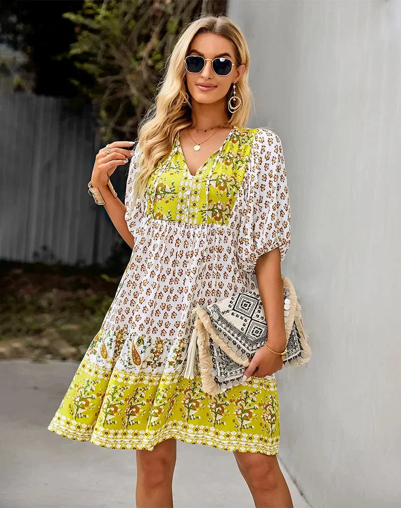 Yellow patchwork midi dress showcasing bohemian charm. Features an eclectic mix of patterns and crafted from soft,…