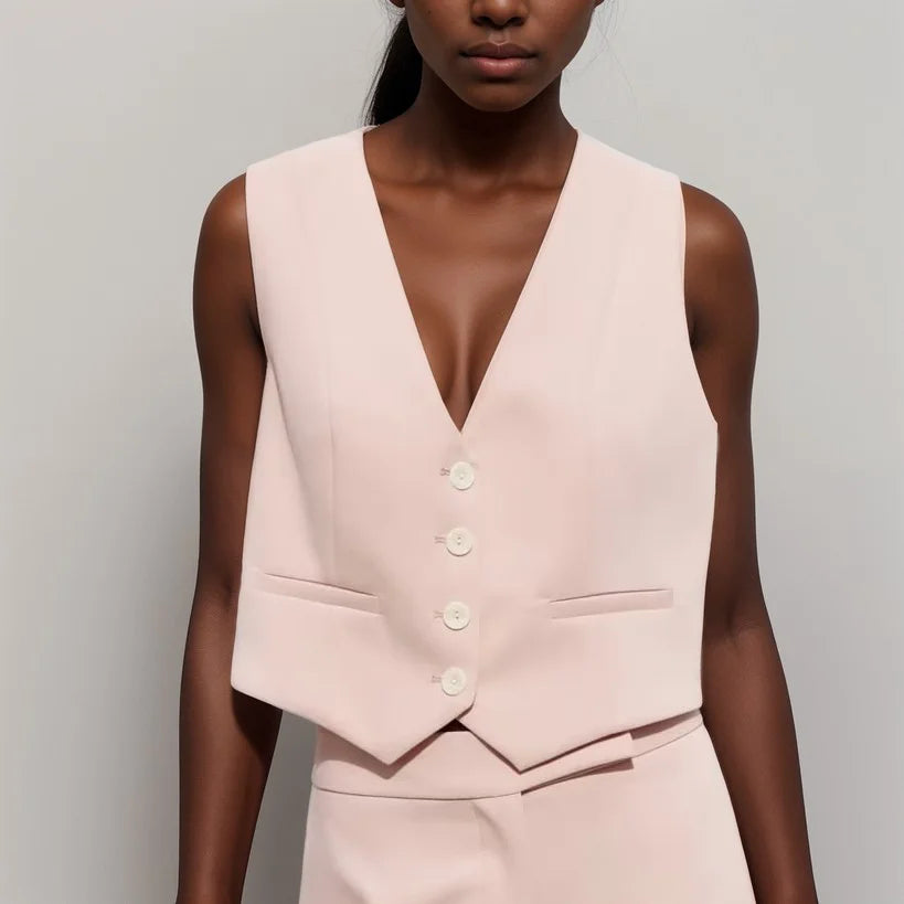 Sleeveless pink top with button details, featuring a sleek and modern design - perfect for a trendy summer look.