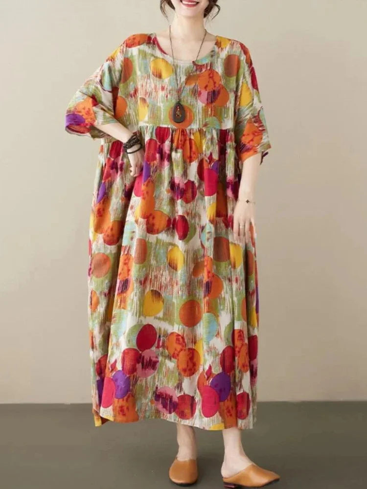 Boho maxi dress featuring vibrant colorful prints on a soft, flowing fabric, perfect for a relaxed yet stylish look.