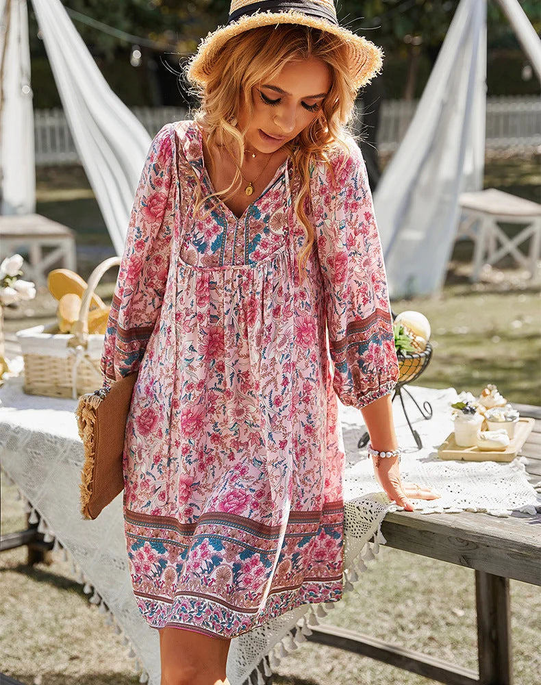 "Pink bohemian floral tunic with sleeves featuring intricate patterns and lightweight fabric."