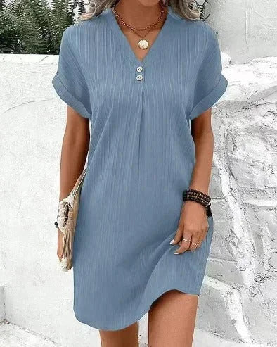 Light blue pleated dress with front buttons for women, made from soft and flowy fabric. Elegant design perfect for any…
