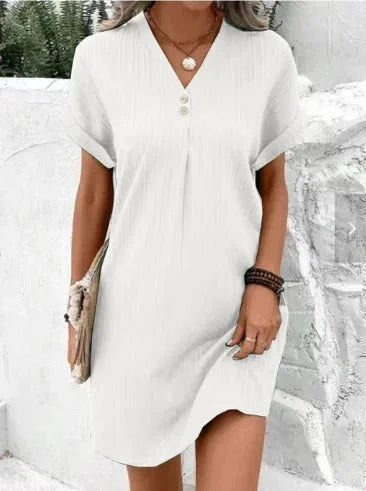White pleated dress with front buttons for women. Flowy and elegant design, made of lightweight and breathable fabric.