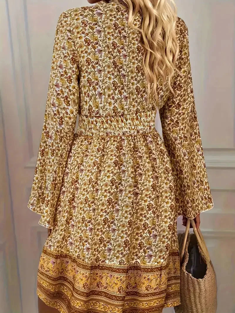 Boho-inspired midi dress with bell sleeves in a flowy fabric with intricate patterns and earthy hues.