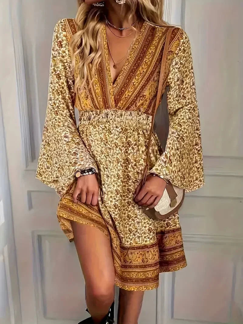 "Beige midi dress with floral embroidery and bell sleeves, perfect for a boho-inspired look."