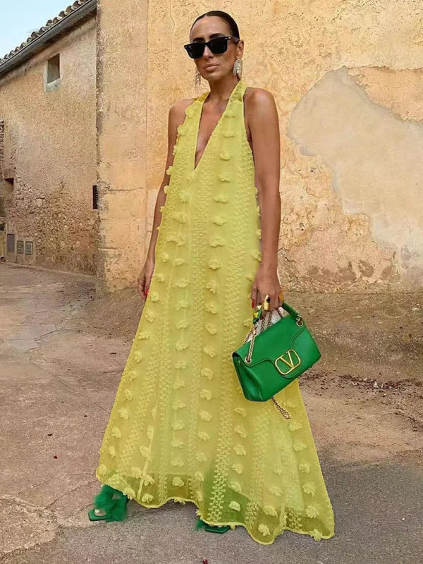 Yellow halter neck floral maxi dress with embellishments, made from lightweight chiffon fabric. Perfect for a casual yet…